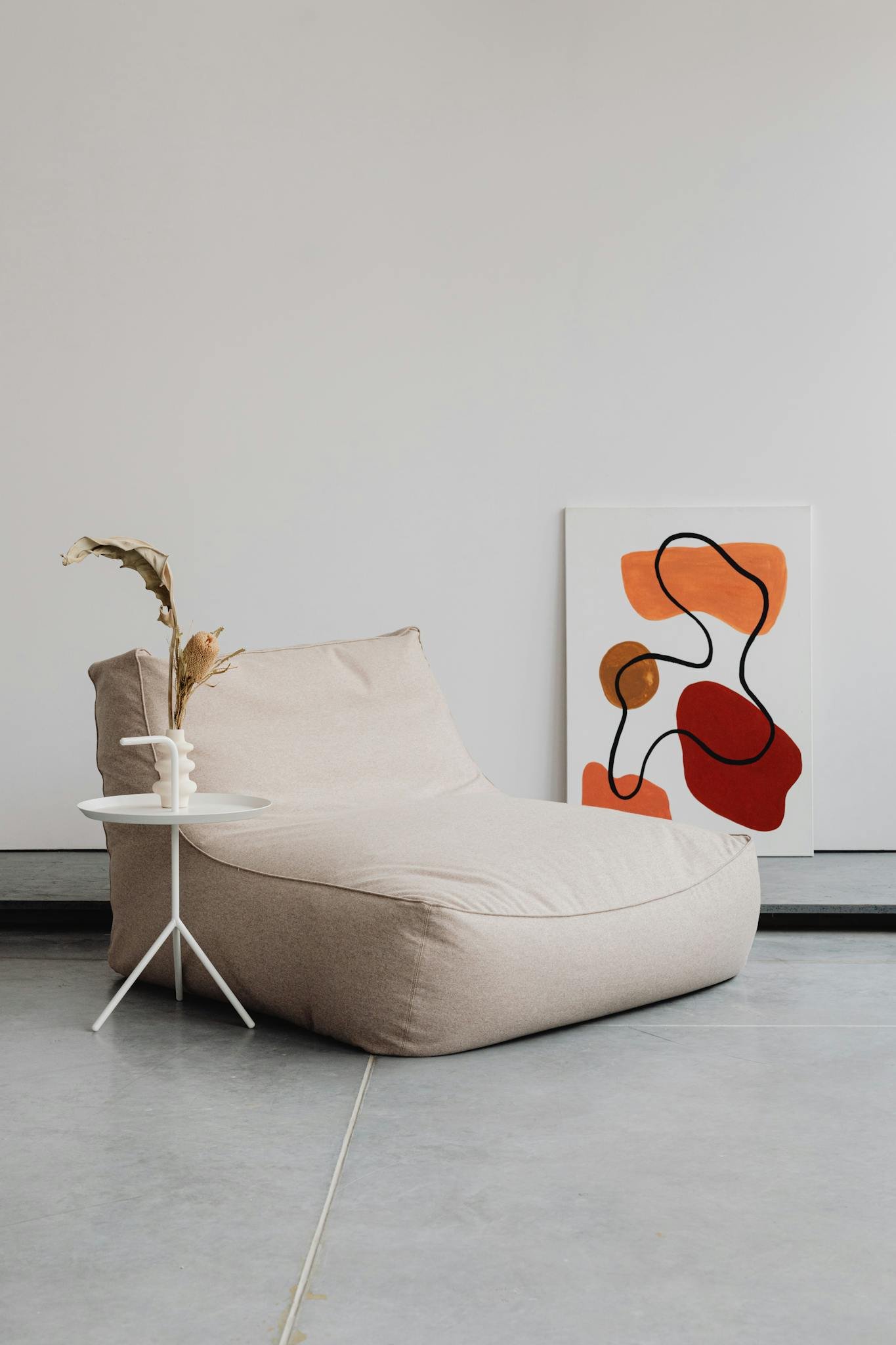A tranquil modern interior featuring minimalist furniture and abstract art.